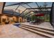 Inviting screened-in pool area with stone steps, lounge chairs, and outdoor dining space for ultimate relaxation at 9801 Pine Leaf Ln, Dade City, FL 33525