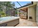 Relaxing screened-in pool area with a hot tub and swing seating for outdoor gatherings at 9801 Pine Leaf Ln, Dade City, FL 33525