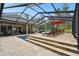 Spacious pool area featuring an in-ground pool, dining area, and lounging spaces for ultimate outdoor relaxation and enjoyment at 9801 Pine Leaf Ln, Dade City, FL 33525
