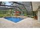 Inviting pool area featuring an in-ground pool, dining area, and landscaping, perfect for relaxation and entertainment at 9801 Pine Leaf Ln, Dade City, FL 33525