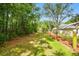 Landscaped property featuring a long driveway with green lawns and mature trees at 9801 Pine Leaf Ln, Dade City, FL 33525
