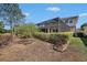 A beautifully landscaped backyard featuring a large screened-in pool and lush green shrubbery at 1018 Tracey Ann Loop, Seffner, FL 33584