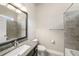 Bathroom featuring granite countertop, framed mirror, tiled shower and floors, and a toilet at 1018 Tracey Ann Loop, Seffner, FL 33584