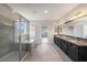 Elegant bathroom showcasing a glass-enclosed shower, soaking tub, double vanity with granite countertops, and gray tile at 1018 Tracey Ann Loop, Seffner, FL 33584