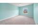 Empty bedroom showcasing light blue walls, carpet flooring, one window, and a ceiling fan at 1018 Tracey Ann Loop, Seffner, FL 33584