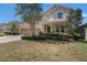 Inviting two-story home featuring a well-manicured lawn, stone accents, and a convenient two-car garage at 1018 Tracey Ann Loop, Seffner, FL 33584