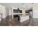 Modern kitchen with dark cabinets, stainless steel appliances, granite countertops, and an oversized island at 1018 Tracey Ann Loop, Seffner, FL 33584