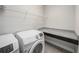 Convenient laundry room with a countertop for folding and modern washer and dryer units at 1018 Tracey Ann Loop, Seffner, FL 33584