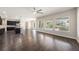 Open-concept layout with a large living room featuring hardwood floors and a view of the beautiful backyard pool at 1018 Tracey Ann Loop, Seffner, FL 33584