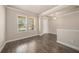 Bright living room with hardwood floors, crown molding, light neutral walls, and large windows at 1018 Tracey Ann Loop, Seffner, FL 33584