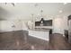 Open-concept layout with a large kitchen featuring an island and easy access to the living room and stairway at 1018 Tracey Ann Loop, Seffner, FL 33584