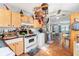 Charming kitchen featuring wood cabinets and a view into the living area at 1021 11Th Nw Ave, Largo, FL 33770