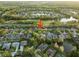 Stunning aerial view of a residential community with lush landscaping, a golf course, and a scenic pond at 10602 Rochester Way, Tampa, FL 33626