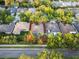 Aerial view of home showcasing backyard pool, mature trees, and a quiet neighborhood at 10602 Rochester Way, Tampa, FL 33626