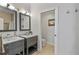 Bathroom featuring double vanity, framed mirrors and separate toilet room at 10602 Rochester Way, Tampa, FL 33626