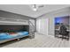 Comfortable bedroom features neutral tones, a ceiling fan, and a built in workstation at 10602 Rochester Way, Tampa, FL 33626