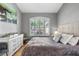 Cozy bedroom with a large window, soft colors, and comfortable furniture at 10602 Rochester Way, Tampa, FL 33626