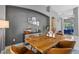 Stylish dining room with a large window, modern sideboard and rustic wood table at 10602 Rochester Way, Tampa, FL 33626