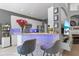 Kitchen features white cabinets, a stone breakfast bar, under cabinet lighting, and barstool seating at 10602 Rochester Way, Tampa, FL 33626