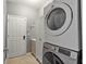 Bright laundry room with front load washer and dryer and plenty of storage at 10602 Rochester Way, Tampa, FL 33626
