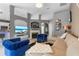 Bright living room with elegant fireplace, blue accent chairs, and comfortable neutral sectional sofa at 10602 Rochester Way, Tampa, FL 33626
