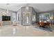 Bright living room featuring gorgeous light fixtures, tile floors, and plantation shutters at 10602 Rochester Way, Tampa, FL 33626