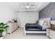 Comfortable main bedroom with stylish decor, including ceiling fan and modern furnishings at 10602 Rochester Way, Tampa, FL 33626