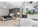 Light-filled main bedroom featuring a decorative accent wall, work area and a ceiling fan at 10602 Rochester Way, Tampa, FL 33626
