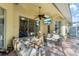 Covered patio with a ceiling fan, outdoor seating, and a mounted TV, perfect for relaxation at 10602 Rochester Way, Tampa, FL 33626