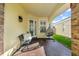 Relaxing front porch area with brick floors, comfortable seating, and decorative egg chair swing at 10602 Rochester Way, Tampa, FL 33626