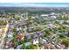 Aerial view of a residential neighborhood with a charming home, a backyard pool, and lush green surroundings at 11777 90Th Ave, Seminole, FL 33772