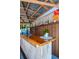 Close up of outdoor bar countertop with bamboo trim, bar decor and wooden beam awning at 11777 90Th Ave, Seminole, FL 33772
