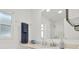 A well lit bathroom with a marble sink and countertop, shower, window, and soft colors at 11777 90Th Ave, Seminole, FL 33772