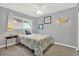 A cozy bedroom with a bed, window, ceiling fan and map decor on the wall at 11777 90Th Ave, Seminole, FL 33772