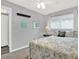 A cozy bedroom with a bed, window, ceiling fan, and simple nautical decor at 11777 90Th Ave, Seminole, FL 33772