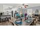 Open-concept dining area featuring a wooden table set for six, seamlessly integrated with the kitchen and living spaces at 11777 90Th Ave, Seminole, FL 33772