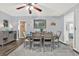 Elegant dining room featuring a wooden table set for six, complemented by modern decor and lighting at 11777 90Th Ave, Seminole, FL 33772