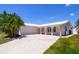 Charming single-story home featuring a two-car garage, arched entry, and well-manicured landscaping at 11777 90Th Ave, Seminole, FL 33772