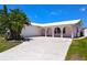 Charming single-story home featuring a white metal roof and arched porch, creating an inviting facade at 11777 90Th Ave, Seminole, FL 33772