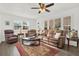 Bright living room with plush leather seating, plantation shutters, and a stylish area rug over wood flooring at 11777 90Th Ave, Seminole, FL 33772
