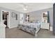 A relaxing main bedroom with a walk in closet, plush carpets, ceiling fan, and beach themed comforter at 11777 90Th Ave, Seminole, FL 33772