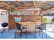 Outdoor bar and grill on a sunny day with nautical decor and wooden counter at 11777 90Th Ave, Seminole, FL 33772