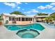 Beautiful backyard pool and spa with an adjacent screened porch and outdoor bar area for entertaining at 11777 90Th Ave, Seminole, FL 33772