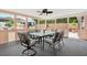 A relaxing outdoor porch featuring comfortable furniture, an outdoor ceiling fan, and a spacious seating area at 11777 90Th Ave, Seminole, FL 33772