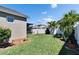 Backyard featuring a shed, well maintained lawn, landscaping, and a vinyl privacy fence at 12664 Flatwood Creek Dr, Gibsonton, FL 33534