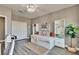 Stylish bedroom featuring a daybed, bookshelves, and ample storage, complemented by a ceiling light fixture and wood floors at 12664 Flatwood Creek Dr, Gibsonton, FL 33534