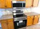 Updated kitchen with stainless steel appliances and wooden cabinetry at 12925 Parkington Dr, Gibsonton, FL 33534