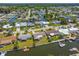 Aerial view of homes along canals with docks, waterfront living, and landscaping in a well-established neighborhood at 13617 Frances Ave, Hudson, FL 34667