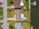 Birds-eye view of a home with a well-manicured lawn, boat dock along a canal, and neighborhood street at 13617 Frances Ave, Hudson, FL 34667