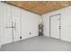 Basement with painted floor and walls with water heater, plumbing and electrical fixtures at 13617 Frances Ave, Hudson, FL 34667